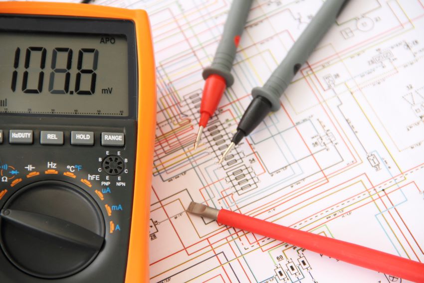 Multimeter and wiring diagram as illustration identifying credentials for technical translations in electrical engineering